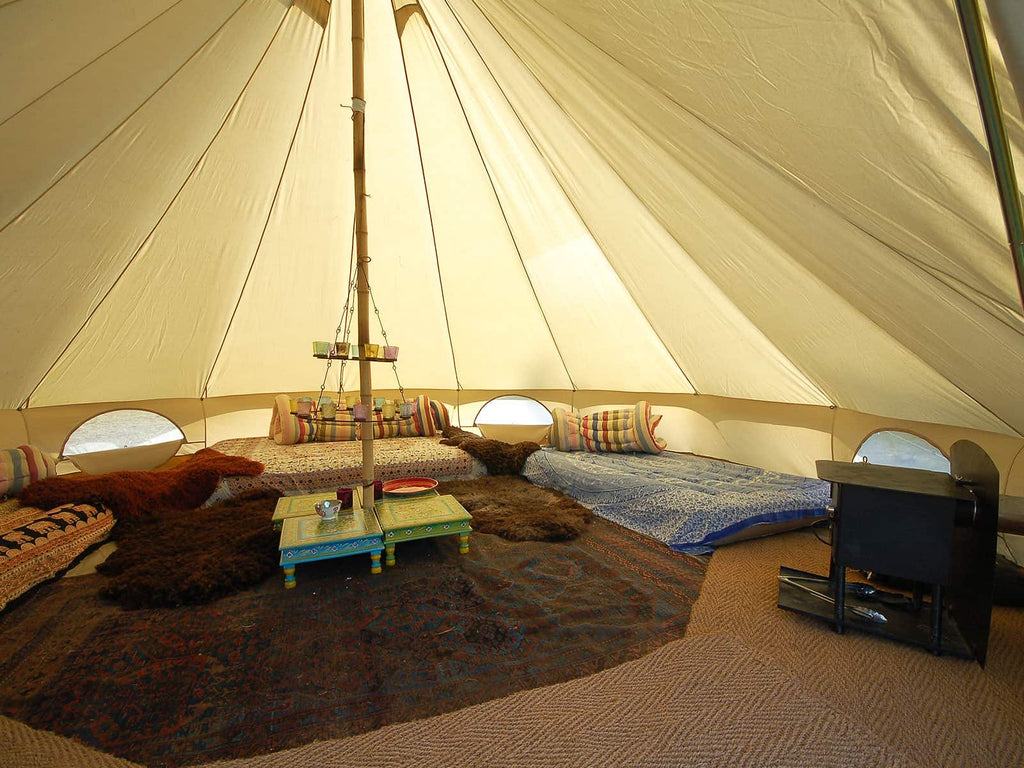 5m deluxe bell tent interior with rugs mattresses and stove