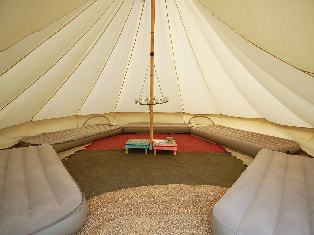 5m deluxe bell tent with rugs, mattresses and a tea light chandelier