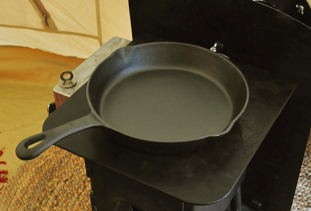8 inch cast iron skillet on a tent stove top
