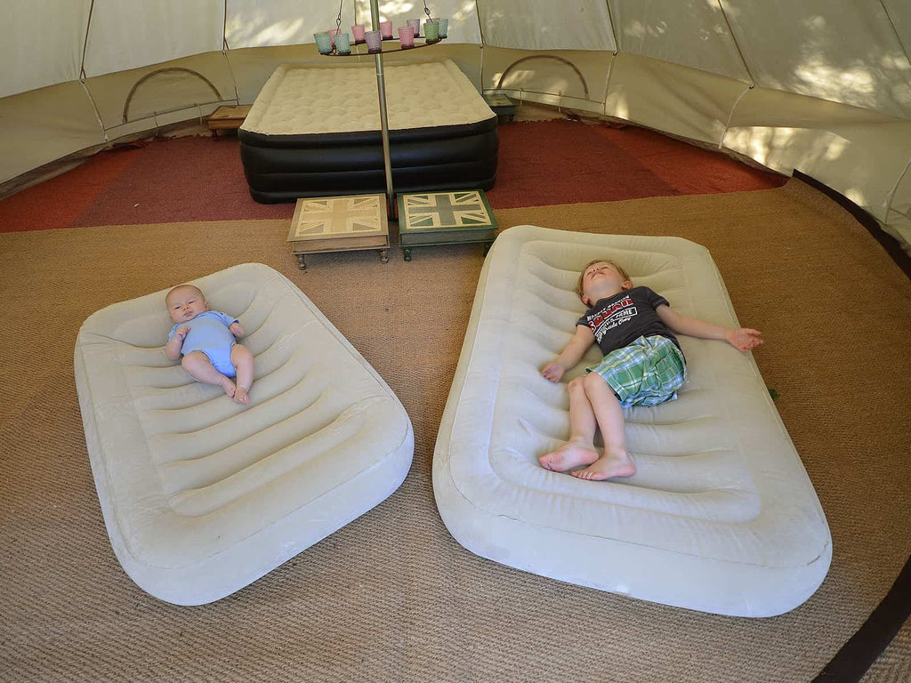 Children's inflatable mattresses inside a bell tent