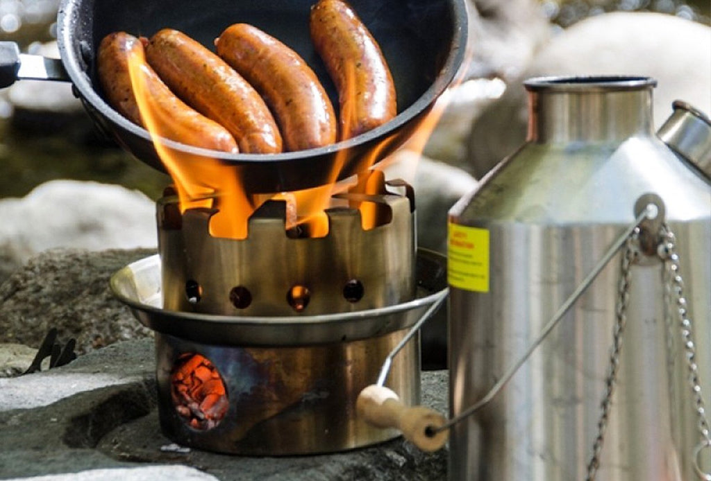 Cooking sausages in a pan with a kelly kettle hobo stove
