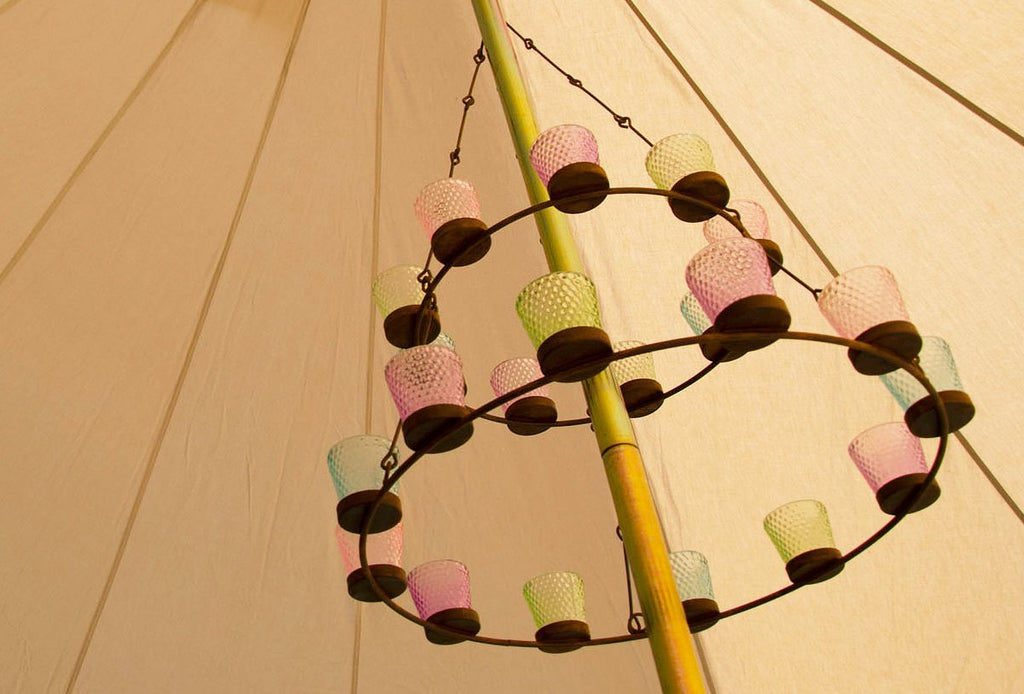 Double multi coloured glass tea light chandelier hanging from a bell tent centre pole