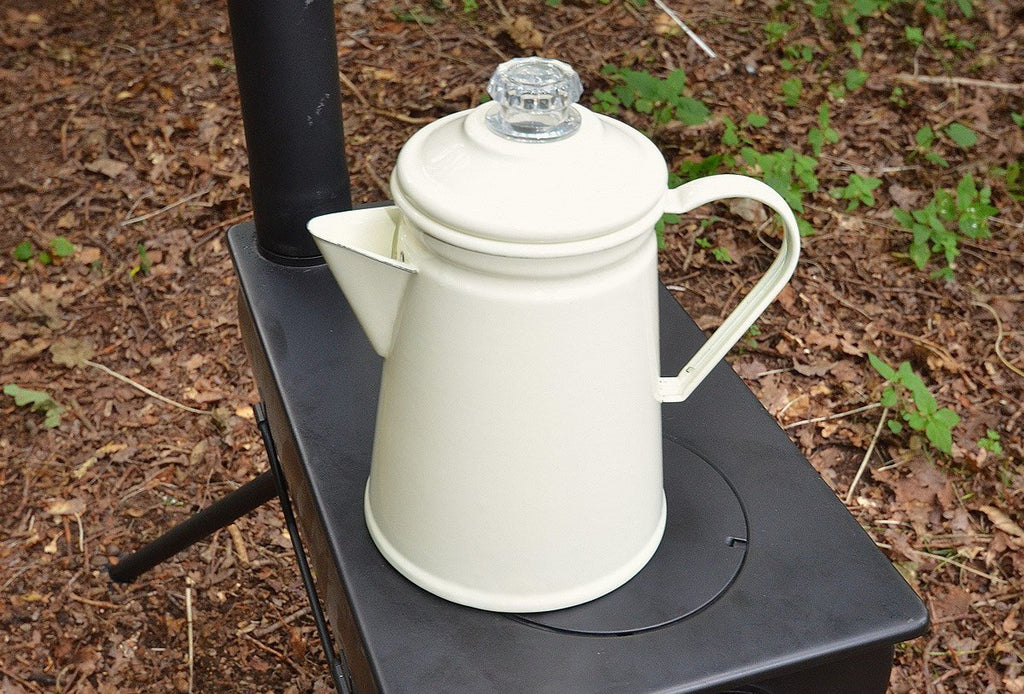 Cream enamel coffee percolator on a frontier stove top