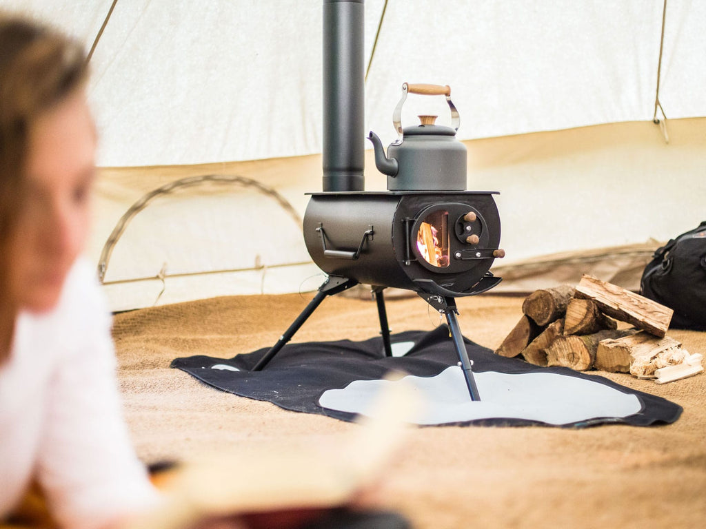 A bell tent with a frontier stove and kettle
