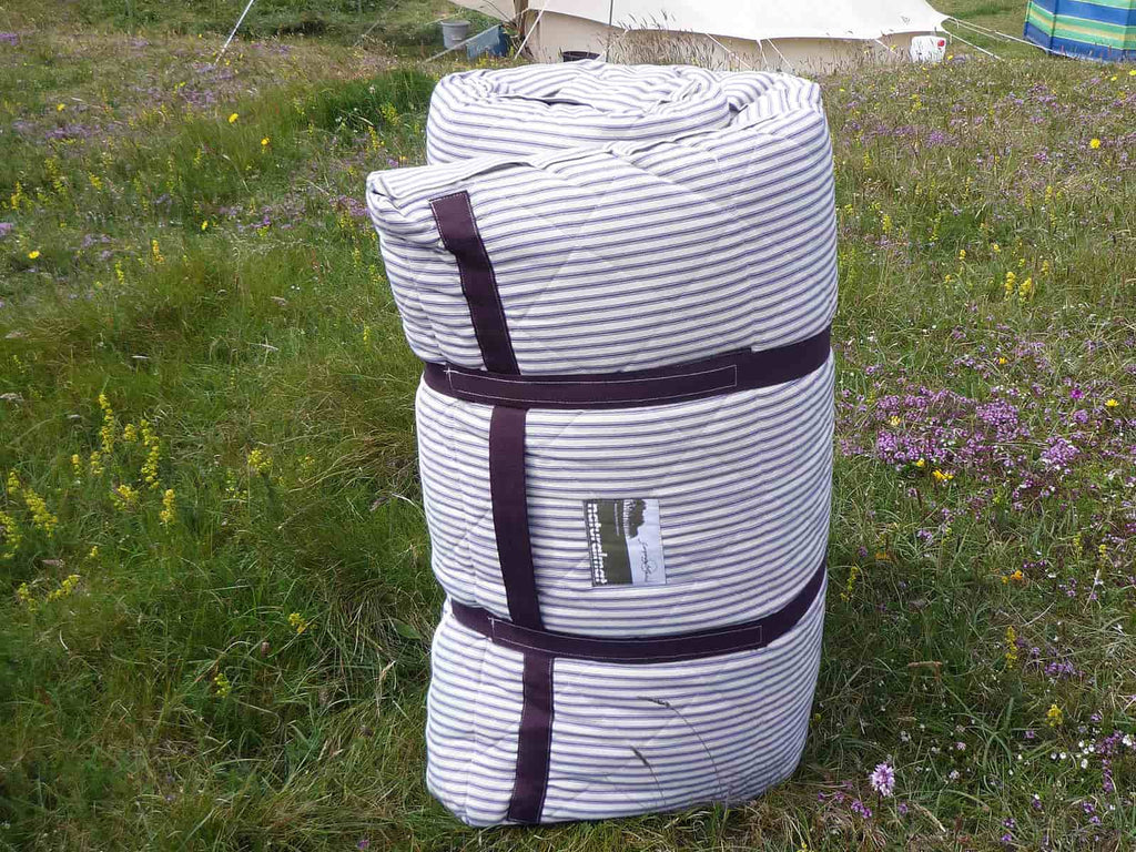 Naturalmat roll up bed for camping in a wild flower meadow 