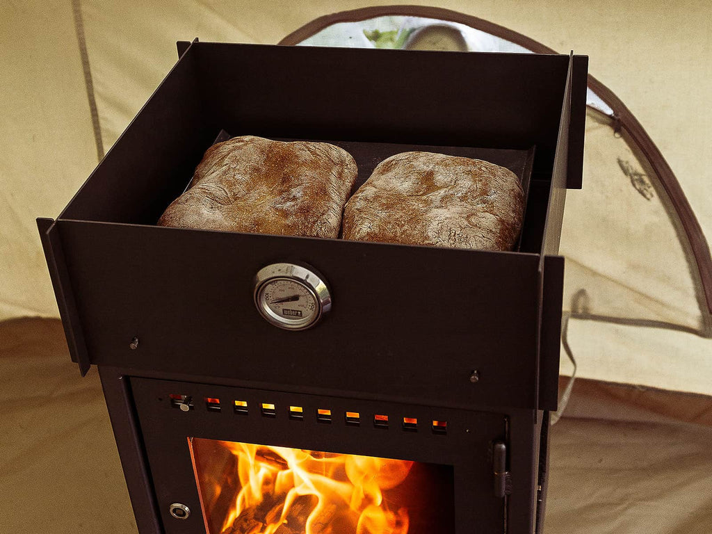 Baking bread in a bell tent with an Orland Camp Stove & Baking Oven