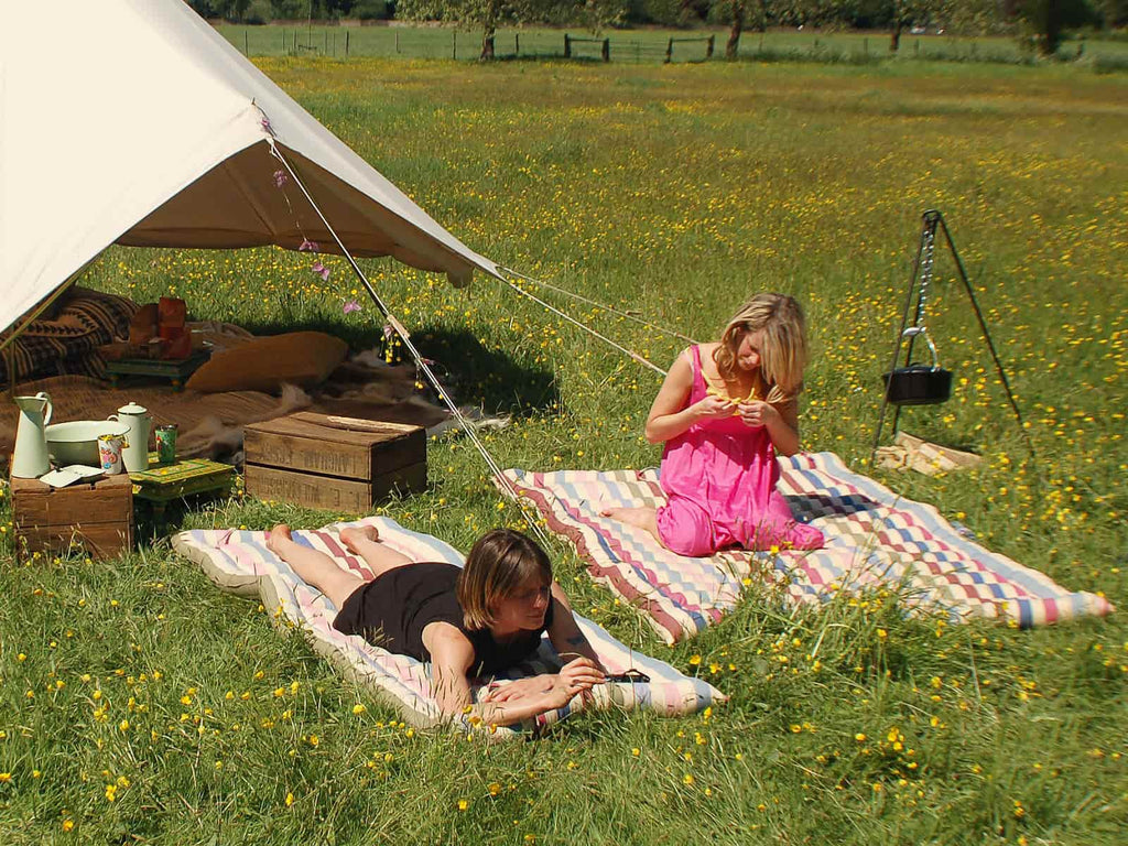 People and bell tent with roll-up cotton mattress
