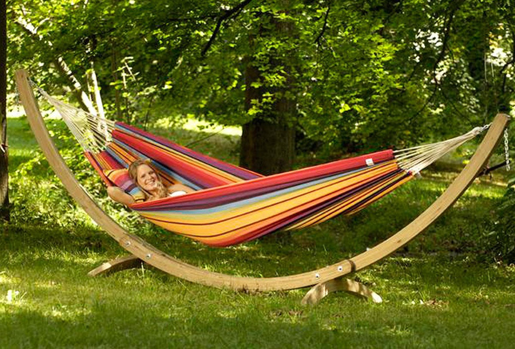 Large wooden hammock stand arc with hammock and person