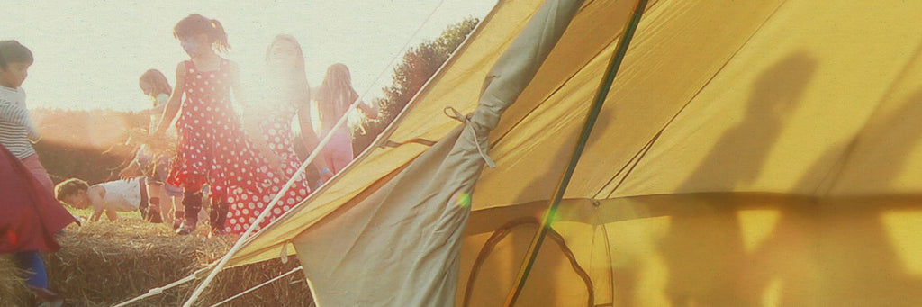 Bell tent camping trip with the sunset casting shadows through canvas.