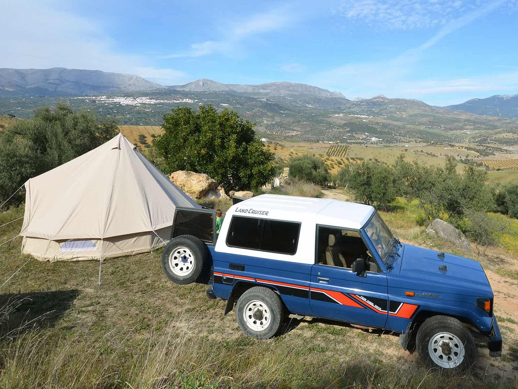 4.5m ultimate bell tent with a jeep in the mountains