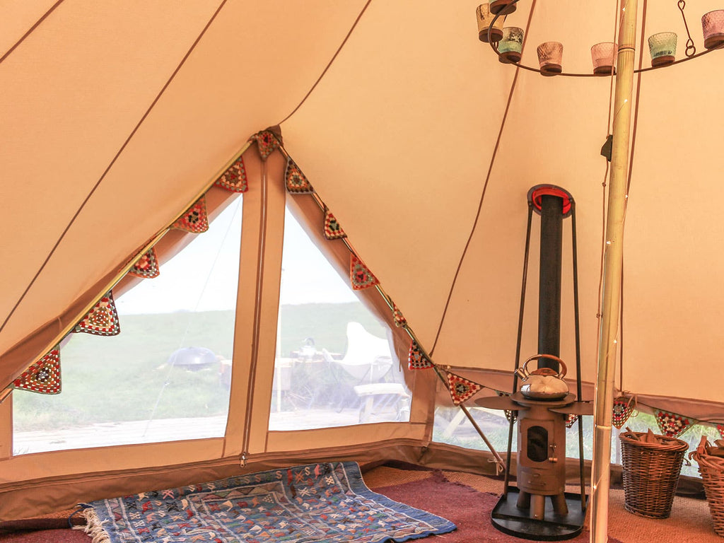 Inside a 4m ultimate pro mesh bell tent with bunting and traveller stove