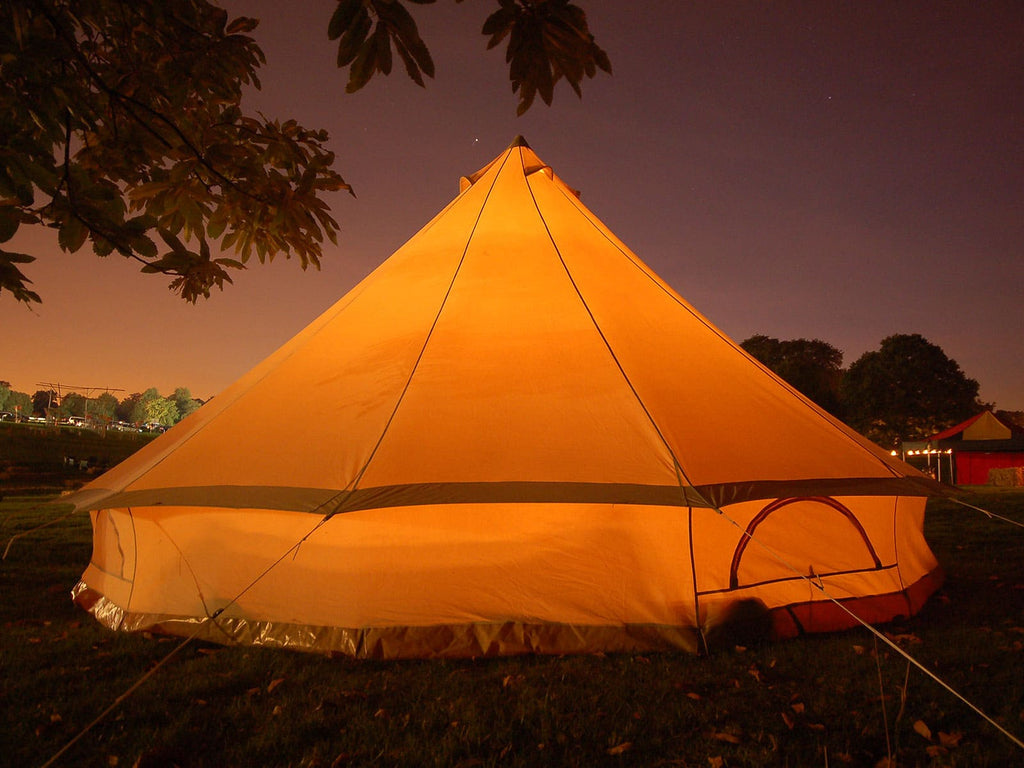 A lit up 5m deluxe bell tent at night 