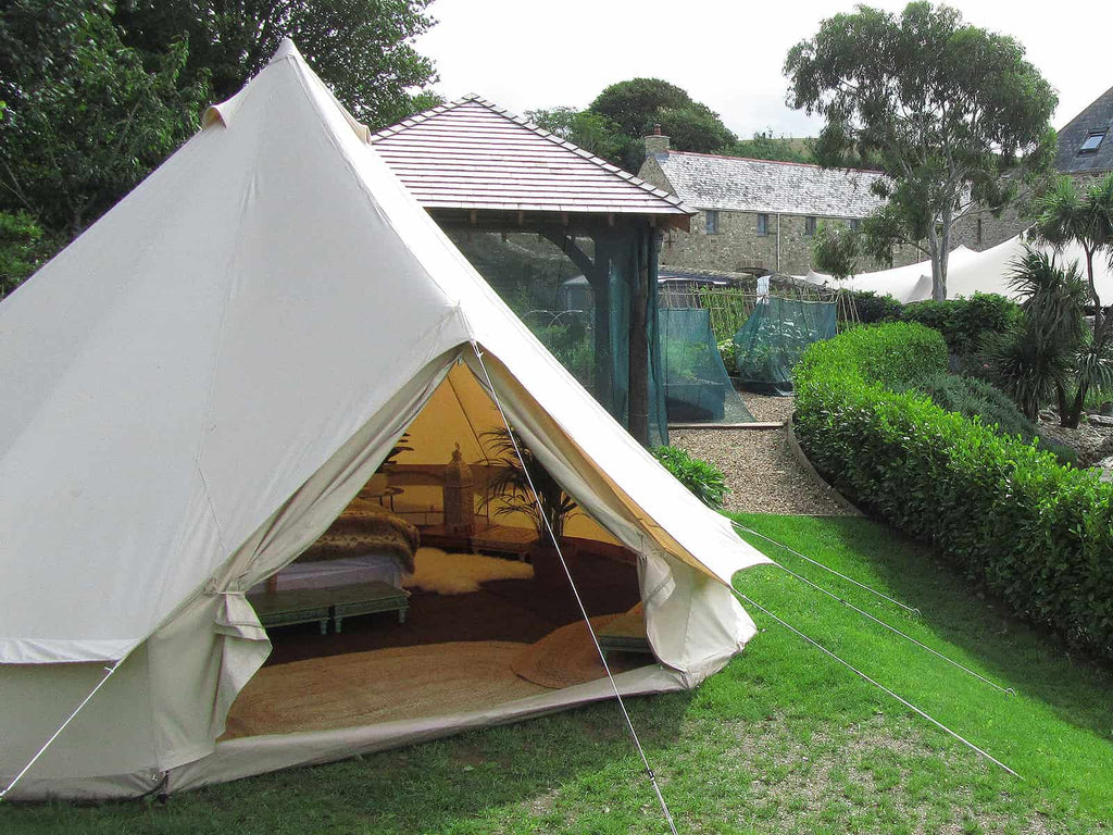 Fully furnished 5m deluxe bell tent pitched in a garden