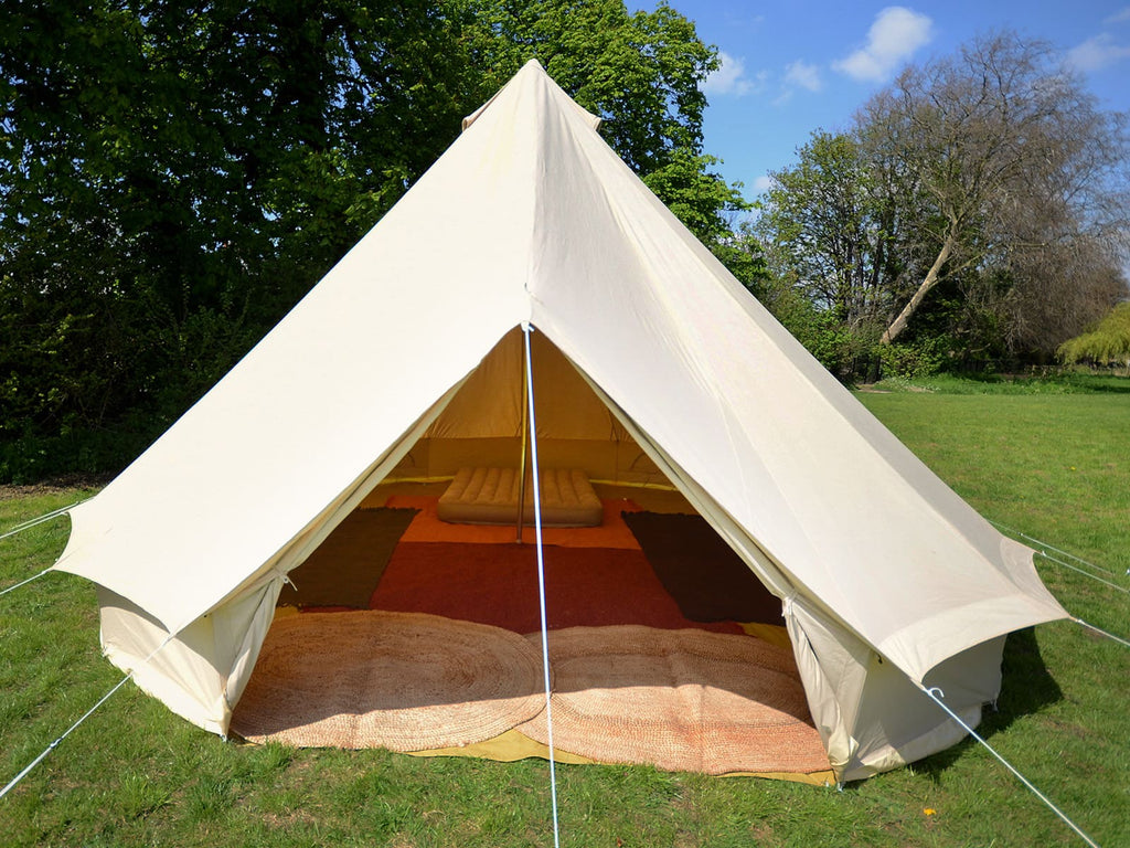 6m standard bell tent with door open and rugs and double mattress