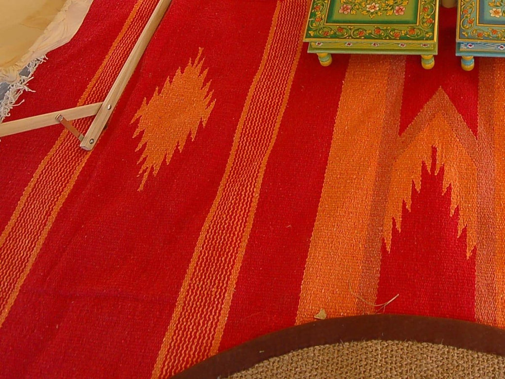 Aztec patterened rug on floor of a bell tent