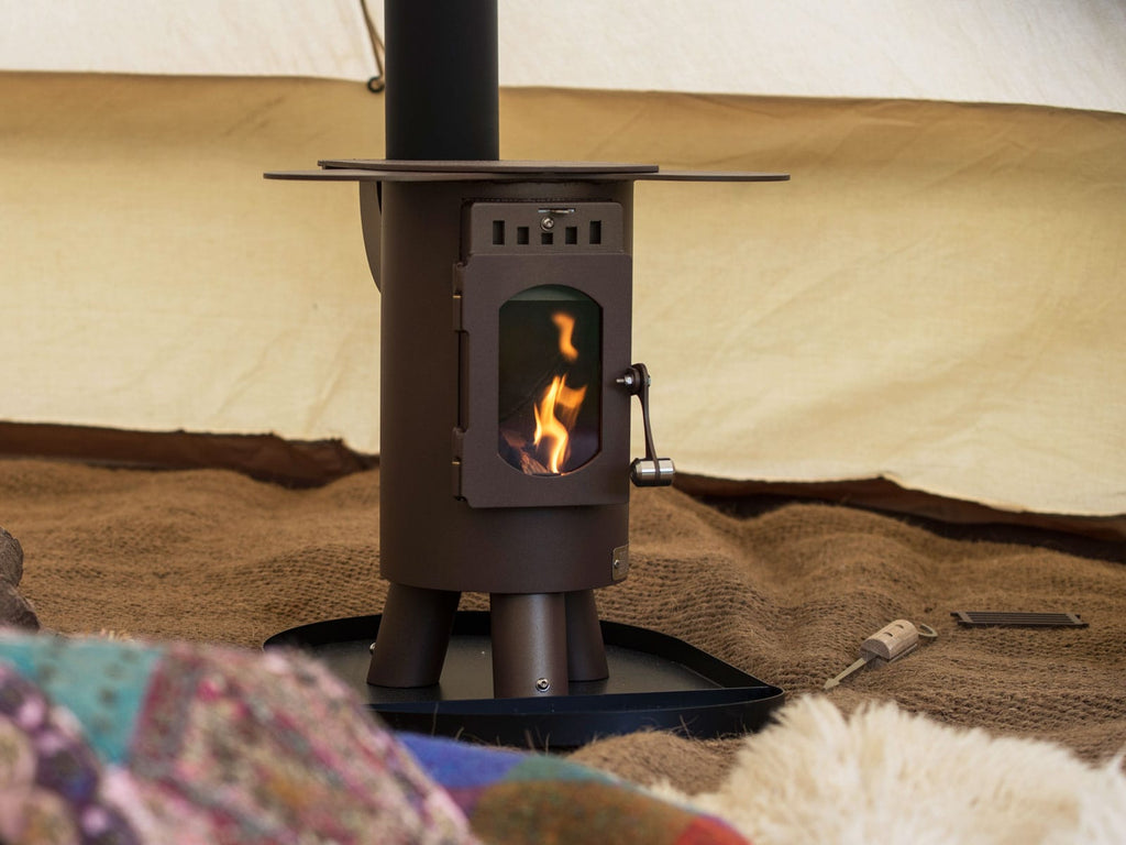Bell Tent with traveller stove and fire burning