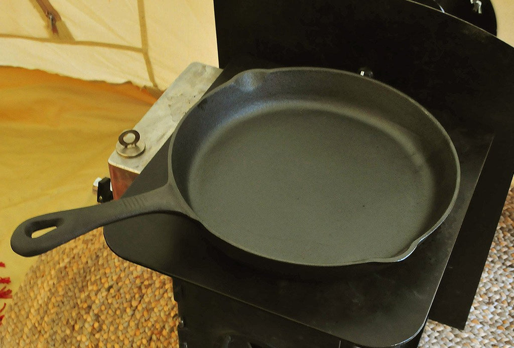 11.5 inch cast iron skillet on a tent stove top
