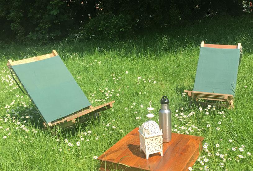 Portable hand-made flat-pack deckchairs indian table and lantern