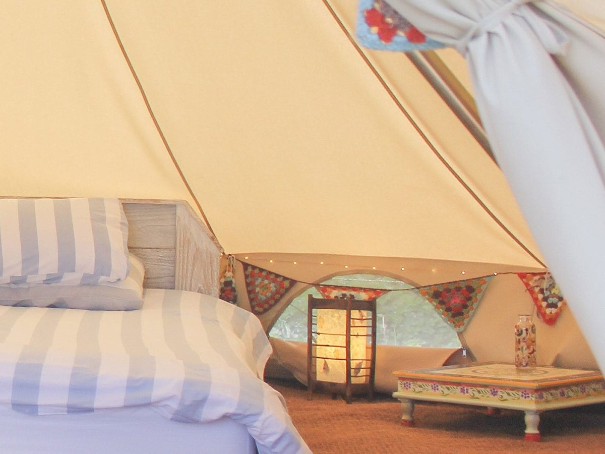 Indian style hand painted square table inside a bell tent