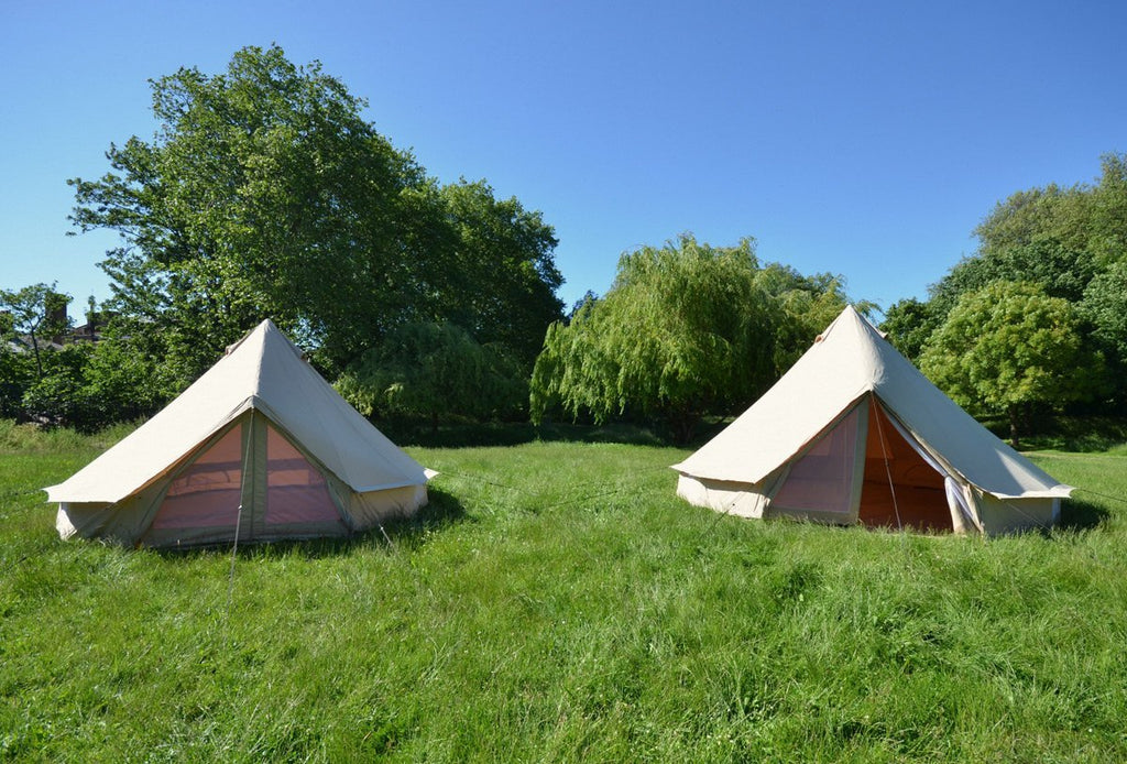 two bell tents with mosquito net doorways