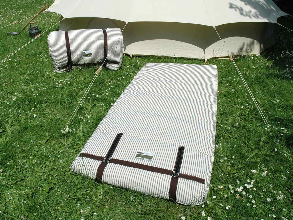 XL naturalmat's on the grass outside of a bell tent
