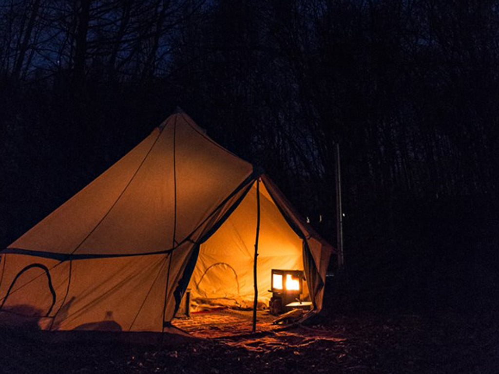Bell tent at night with orland tent stove