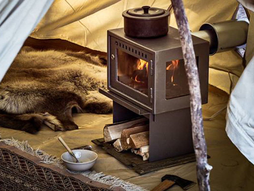 Orland Tent Stove inside a bell tent with fur rugs
