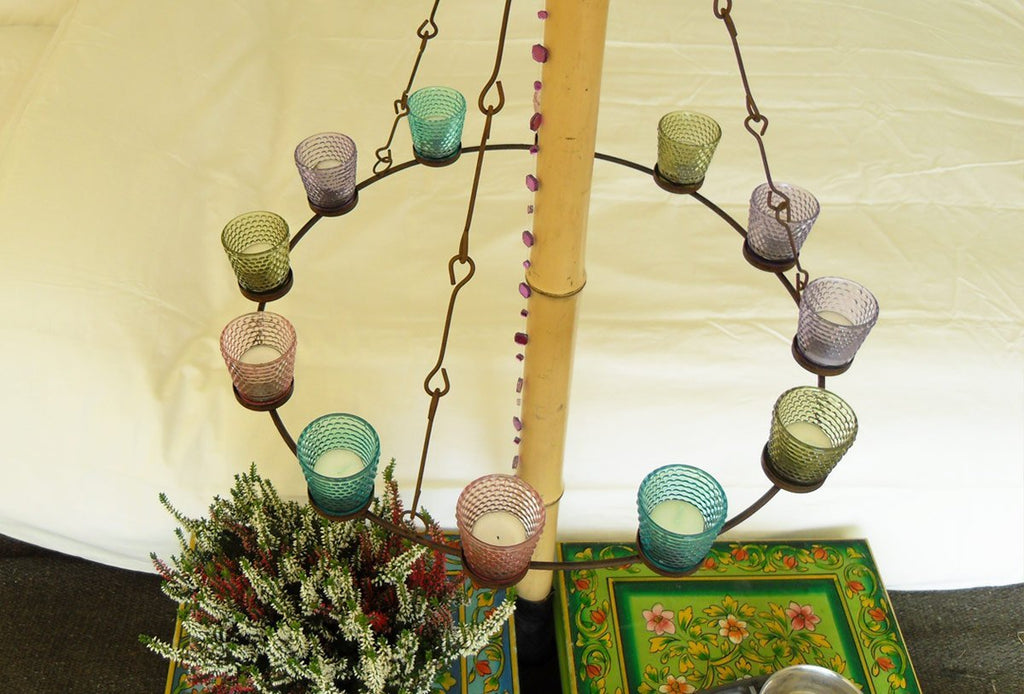Single tier multi coloured glass tea light chandelier in a bell tent on a bamboocentre pole